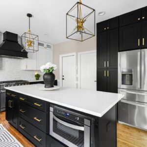 A kitchen with maple black cabinets.