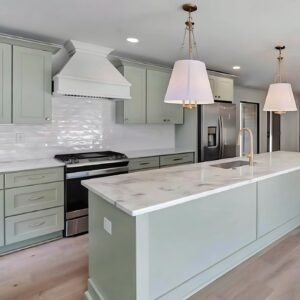 A kitchen with maple green cabinets.