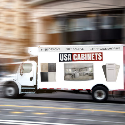 A side shot of a truck that is in motion with USA Cabinets branding on the side of the truck.